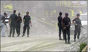 Indonesian elite police officers of Mobile Brigade (BRIMOB) stand guard at the ambush site