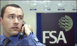 Financial Services Authority worker on phone in emergency HQ
