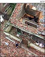 South Korean residents stand helplessly looking over their demolished two-storey brick house