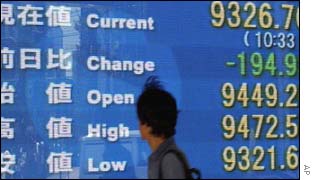 Man looking at board of Japan stock market