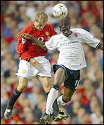 Joseph Desire-Job and Phil Neville leap for the ball