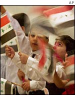 Iraqi children wave Iraqi flags