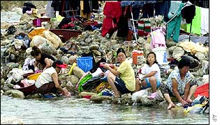 People washing their clothes by a riverbank in Donghae
