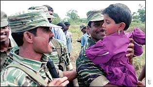 Tamil Tiger combatants joke with a Tamil child in Omantha