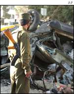Soldier inspecting the bomb damage