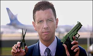 Mike Pearse with scissors and replica gun