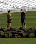 Workers lifting the turf