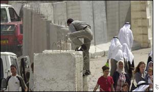Israeli border police officers patrol on the east Jerusalem side of Abu Dis