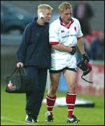 Neil McMillen departs the field before half-time 