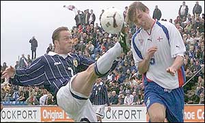 Paul Dickov challenges against Jon Roi Jacobsen