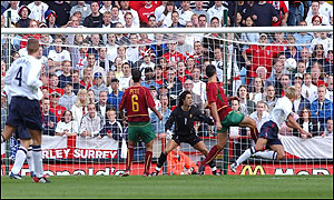 Alan Smith (right) heads home for England