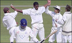 Alex Tudor (centre) celebrates one of his seven wickets against Sussex
