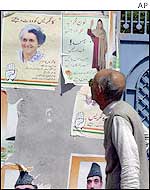 Kashmiri man reads election posters in Srinagar
