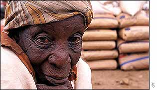 Zimbabwean woman sits by relief food in the Nhwali area
