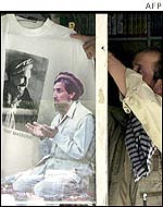 An Afghan shopkeeper puts a T-shirt on display carrying a picture of Masood