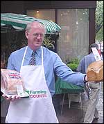 National Farmers Union President Ben Gill in an apron at farmers market