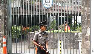 An armed Indonesian police officer stands guard at the gate of the U.S. embassy in Jakarta on Tuesday