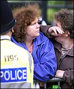 Member of the crowd wipes away tears