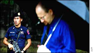 A man pauses in silence in Bangkok