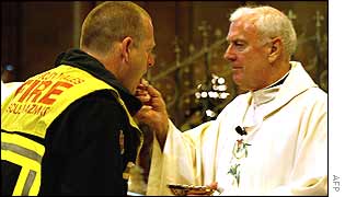 A firefighter receives communion in Sydney