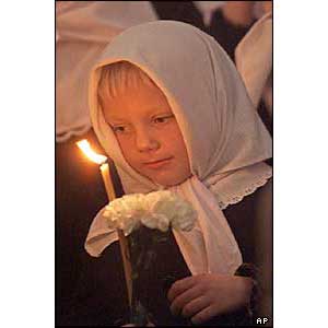 A Russian girl stands during a religious service at Moscow's St. Yekaterina Cathedral 