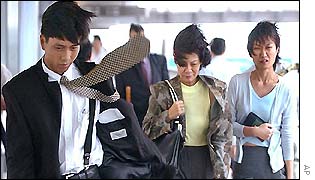 Hong Kong residents walking in high winds