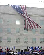 A flag is unfurled on the Pentagon's rebuilt wall
