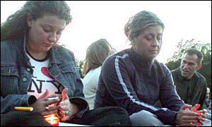 Women hold candles in memoriam in Central Park, New York City