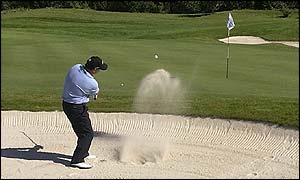 Wales' Ian Woosnam chips out of a bunker at the sixth hole