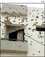 Bullet-scarred walls of the Karachi apartment building