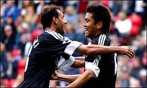 Inamoto is congratulated by Sylvain Legwinski