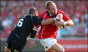 Scott Quinnell is tackled by Neath blindside Hywel Jenkins