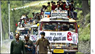 Crowded buses carry supporters of the ruling National Conference campaign