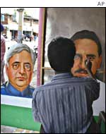 An artist finishes a poster of candidate Ashok Kazuria 