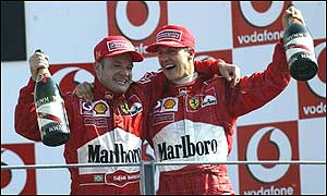 Rubens Barrichello and Michael Schumacher celebrate their podium finishes