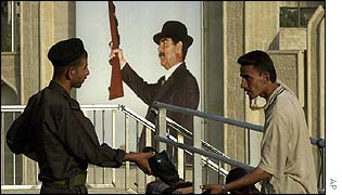 An Iraqi soldier and a shoe vendor in Baghdad