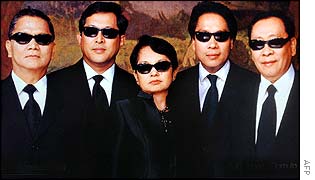 President Gloria Arroyo (centre), with top cabinet members, on the cover of Philippine Tatler magazine dressed like Men in Black characters
