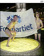 Liberal Party supporters celebrate in the Sergel Square fountain in central Stockholm