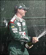 Eddie Irvine lets loose the champagne