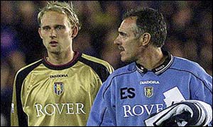 Aston Villa keeper Peter Enckleman walks off with coach Eric Steele 