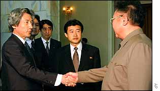 Koizumi (L) shakes hands with Kim Jong-Il 
