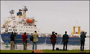 Photographers wait on dockside