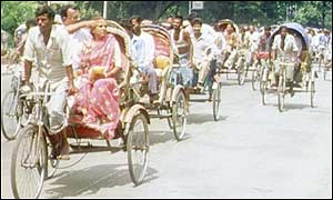 Row of cycle rickshaws on a Dhaka street