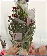 Flowers mark the spot where a victim was killed