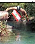 Lebanese boy jumps from the new water pipes built on the Wazzani River 