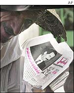 An Iraqi man holding a newspaper