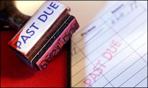 Red debt stamp alongside an overdue bill