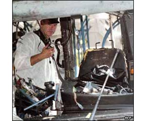 Security staff examine the driver's seat