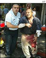 Injured man being helped away