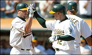 Terrence Long (right) is congratulated after his two-run homer
